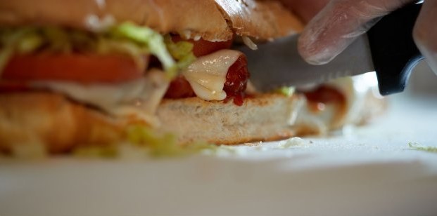 Fresh sub sandwich being sliced